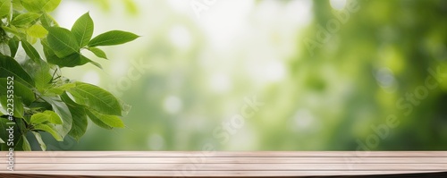Empty wooden tabletop on wooden floor with blur abstract green leaf nature's beauty background