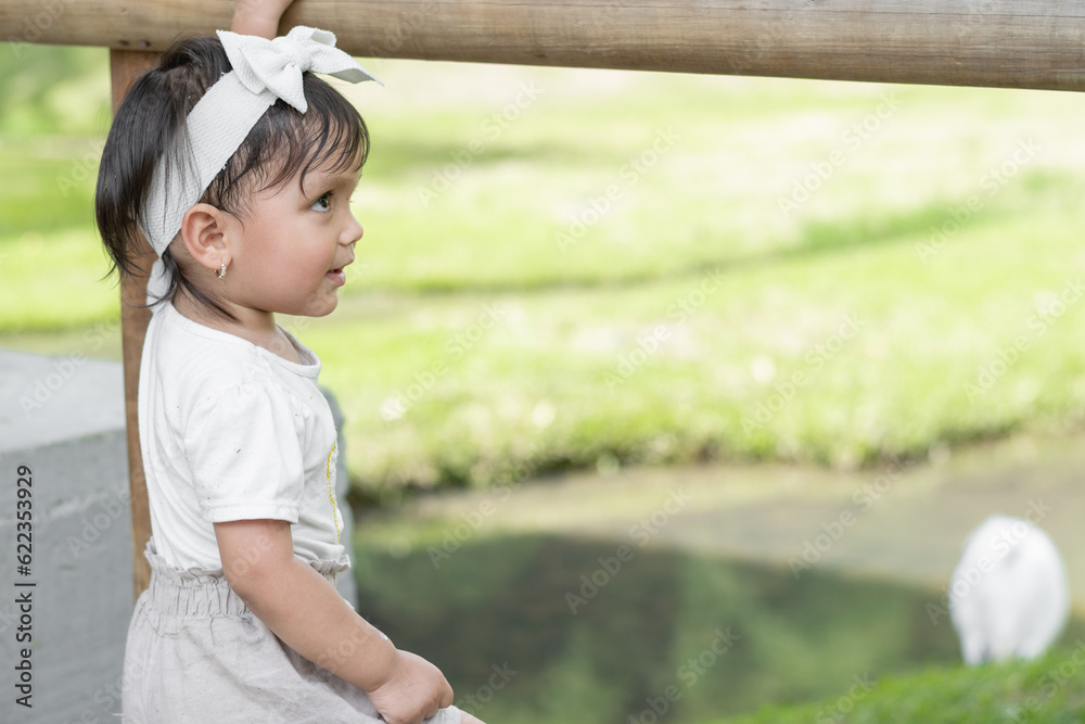 profile view of a little brunette Latina girl, looking sideways with a smile. profile view of a little brunette Latina girl, looking sideways with a smile.