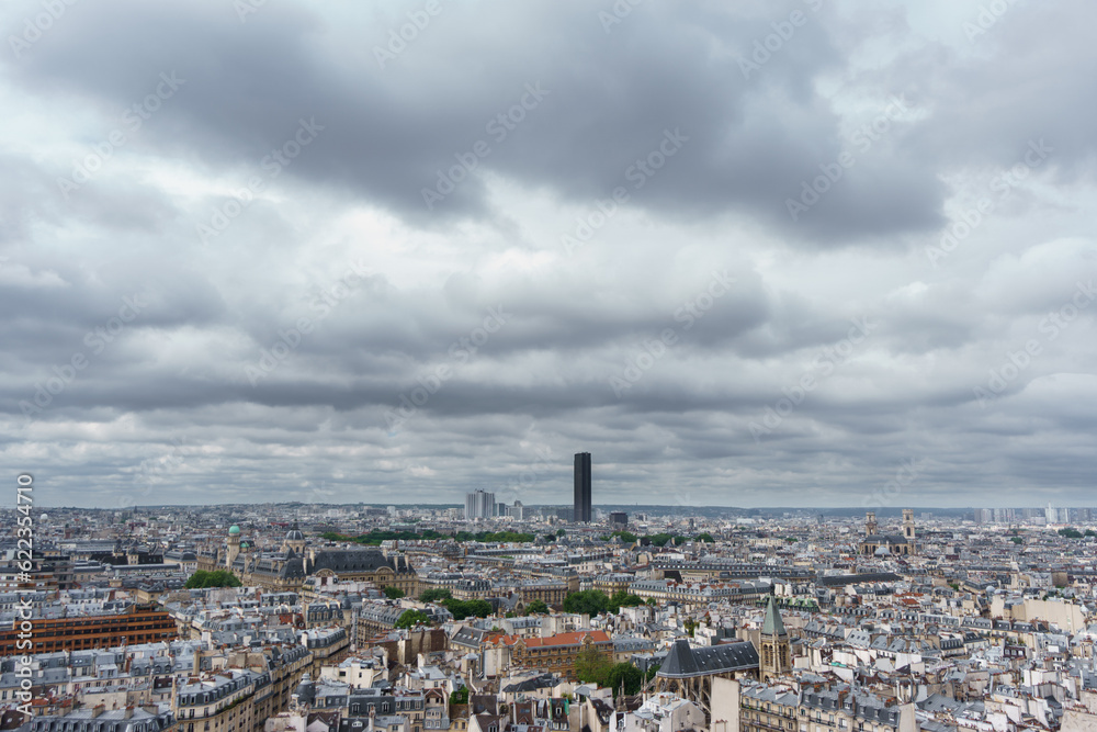 Cloudy day with Montparnasse tower over Paris roofs skyline