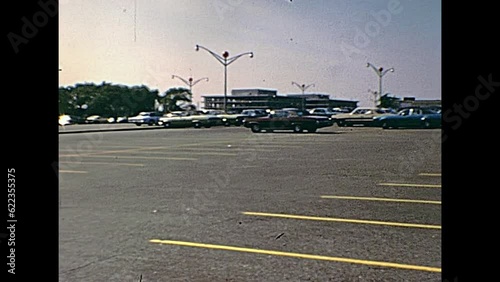 Swansea, United States of America - circa 1970: Old footage of people and vintage cars in the parking lot of Macy's Shop Fashion Clothing and Accessories, on Swansea Mall Drive in 70's.