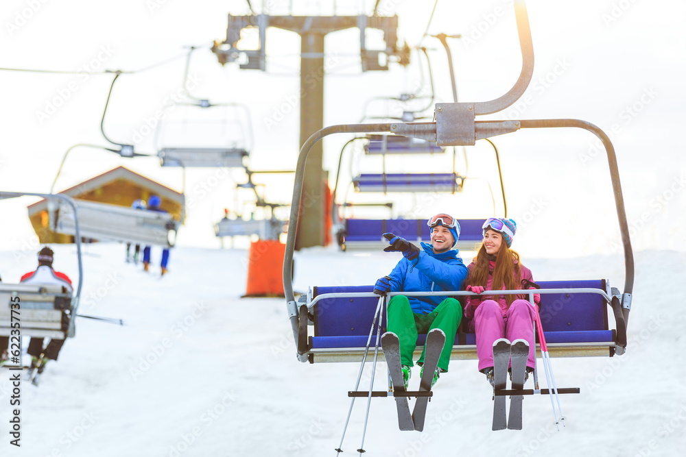 Smiling couple in sportswear on a lift Smiling couple in sportswear on a lift