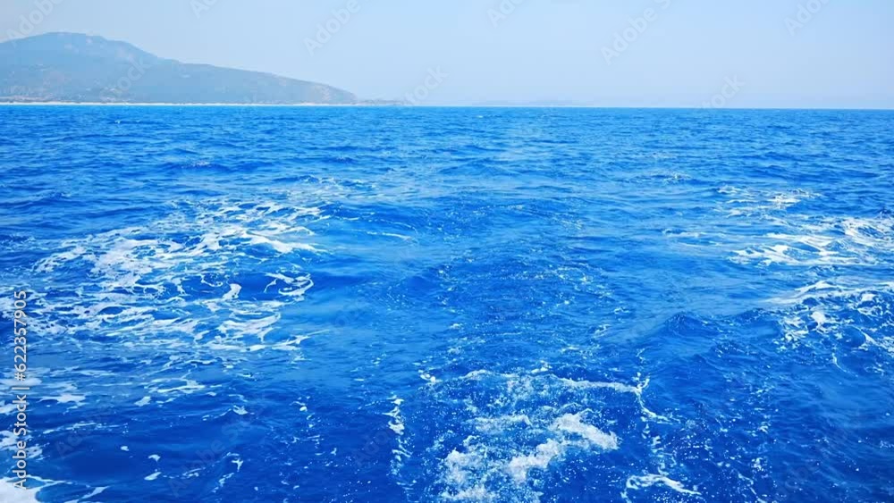 Water surface behind of sailing boat with blue sky. Water surface behind of sailing boat with blue sky.