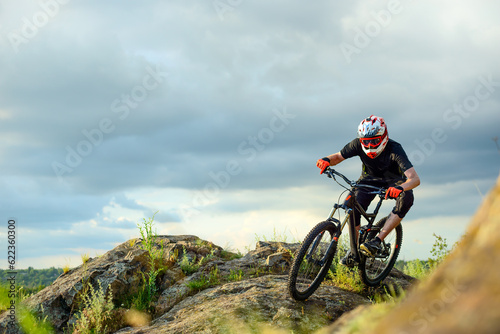 Professional Cyclist Riding the Bike on the Rocky Trail. Extreme Sport Concept.