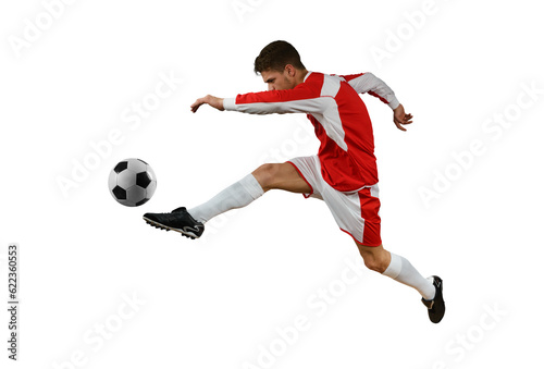 Soccer player kicks the soccerball in the air by jumping