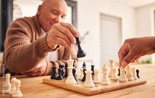Senior man, home and chess for games, competition and focus with friends, strategy and problem solving. Elderly person, hands and board for contest with mindset, excited smile and moving at table