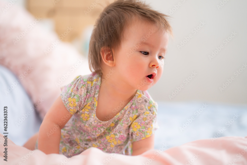 lifestyle home portrait of happy and adorable 9 months old mixed ethnicity Asian Caucasian baby girl playing cheerful and carefree on bed looking sweet and cute in childhood concept lifestyle home portrait of happy and adorable 9 months old mixed ethnicity Asian Caucasian baby girl playing cheerful and carefree on bed looking sweet and cute in childhood concept