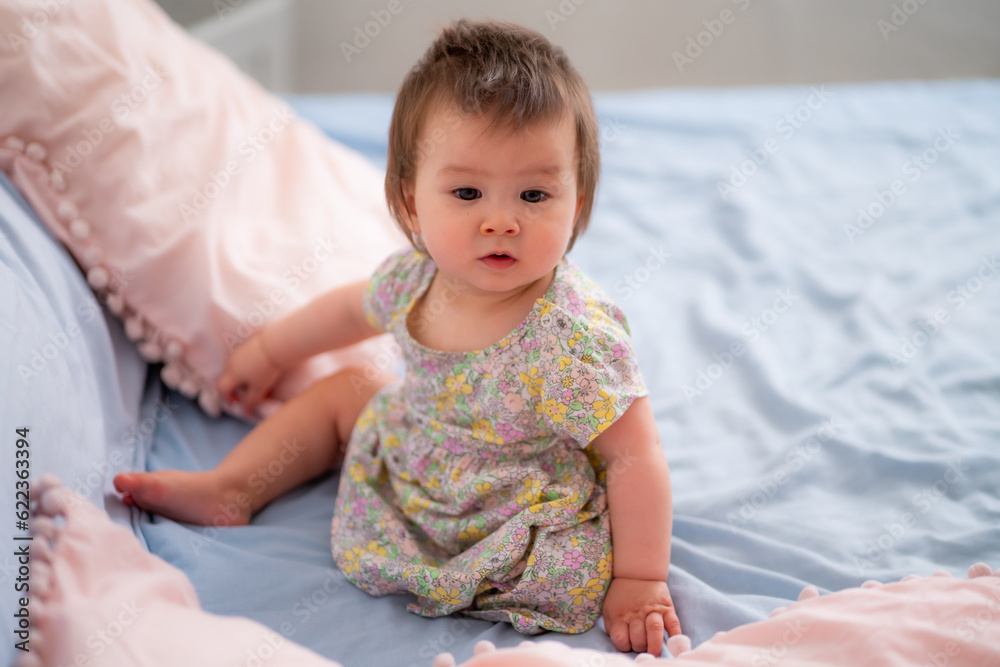 lifestyle home portrait of happy and adorable 9 months old mixed ethnicity Asian Caucasian baby girl playing cheerful and carefree on bed looking sweet and cute in childhood concept lifestyle home portrait of happy and adorable 9 months old mixed ethnicity Asian Caucasian baby girl playing cheerful and carefree on bed looking sweet and cute in childhood concept