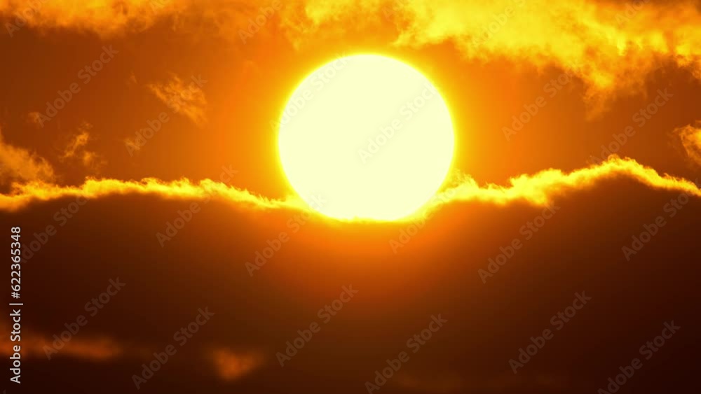 Cinematic sun set at red yellow and orange sky timelapse. Hot summer atmosphere at heat wave. Yellow sun setting at epic golden hour time lapse. Close up view of big round sun disk.