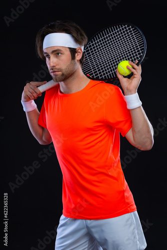 Tennis player with racket. Man athlete playing isolated on black background. © Mike Orlov