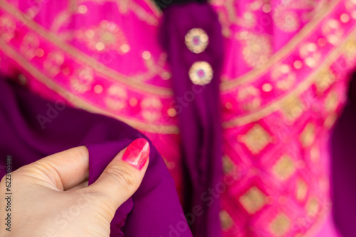 indian colorful pink and purple dress with golden pattern. photo