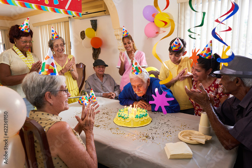 Photography Group of old friends and family celebrating senior man 80 birthday party in retirement home