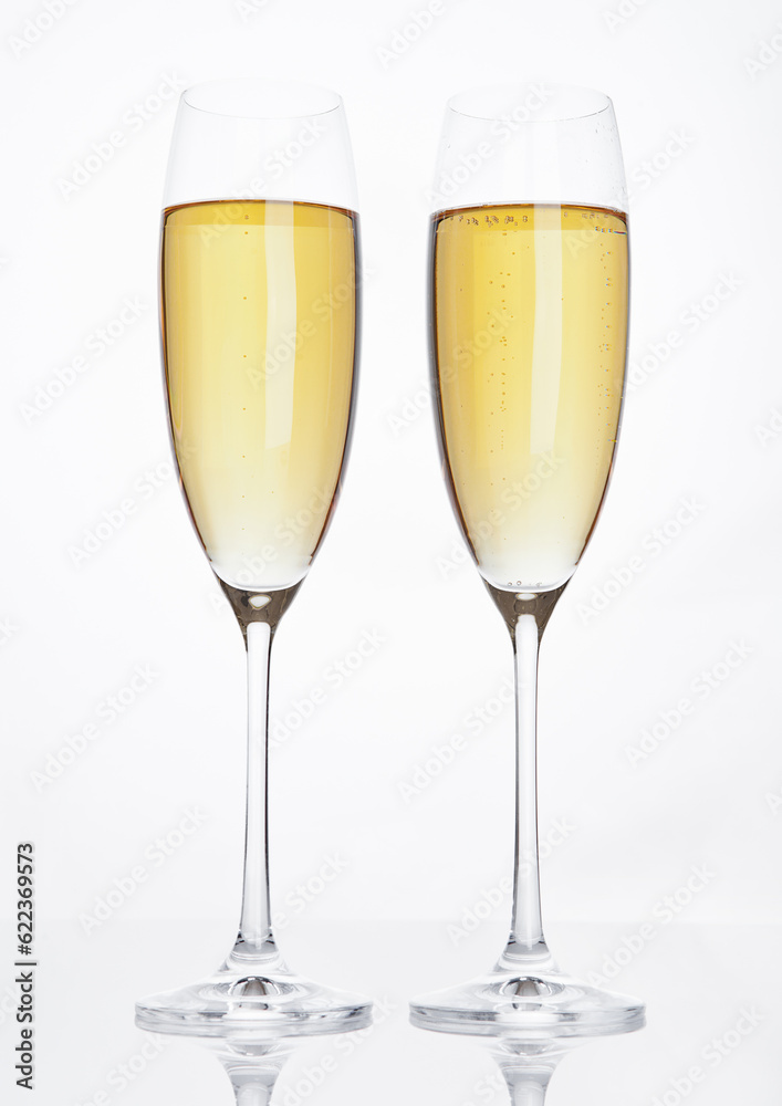 Glasses of sparkling champagne with bubbles on white background Glasses of sparkling champagne with bubbles on white background