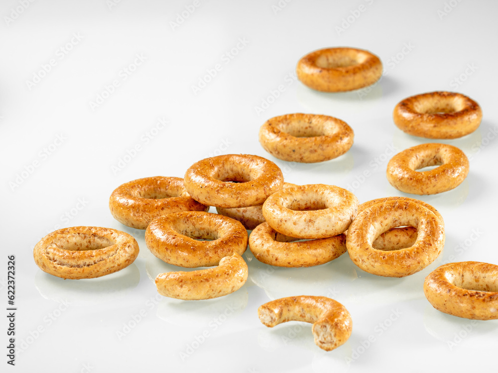 Fast food. Heap of crispy pretzels for breakfast on white background