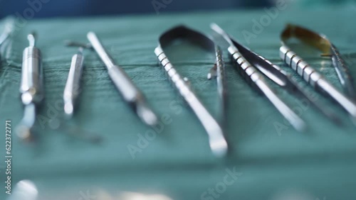 Shot of dentist tools on a green background. Forceps curved, explorer curved, dental explorer angular. Hygiene. Health