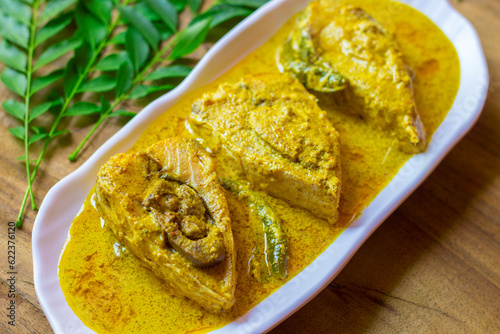 selective focus of Illish or Hilsa fish cooking with mustard seed.famous in India and Bangladesh.  photo