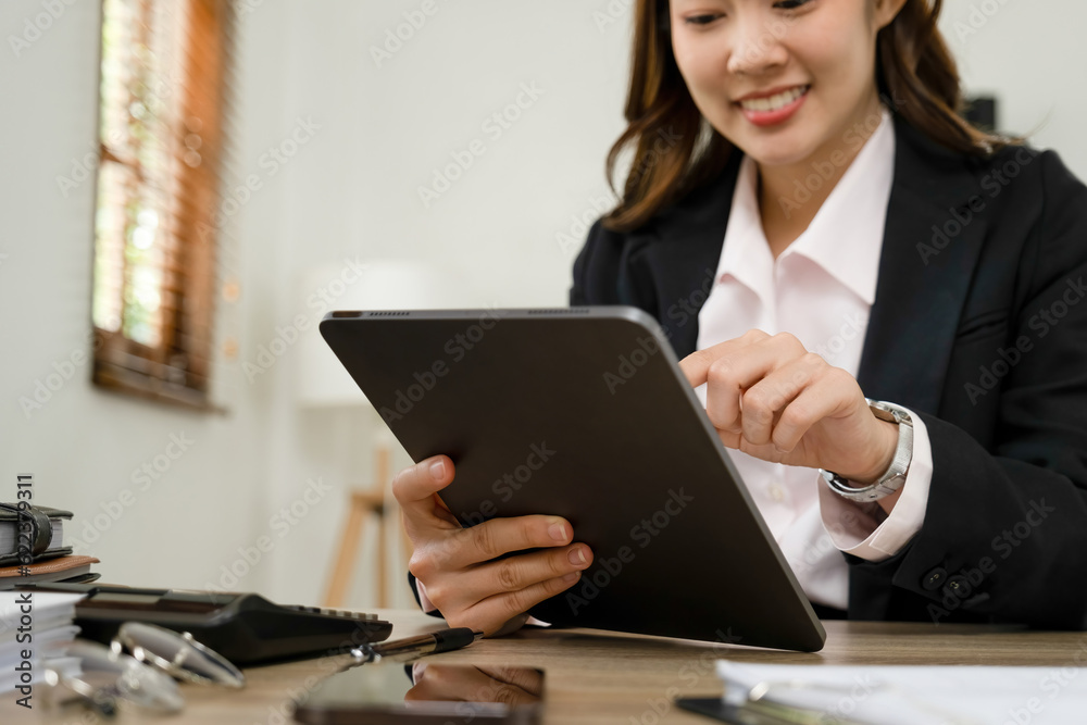 Businesswoman working at desk using tablet. Businesswoman working at desk using tablet.
