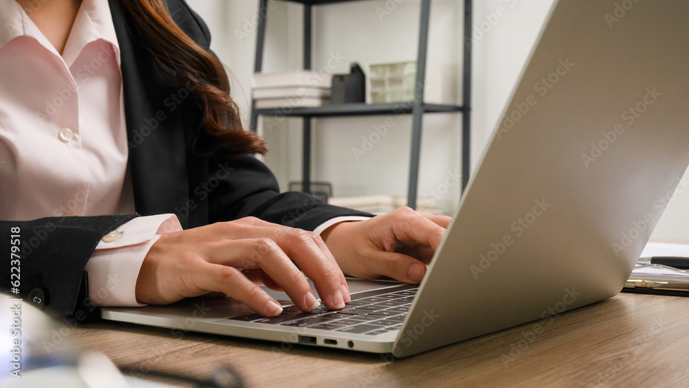 Busineswoman working in office using laptop. Busineswoman working in office using laptop.
