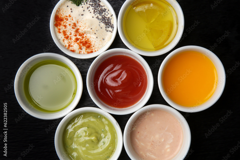 Different sauces and dips in bowls on the restaurant table
Different sauces and dips in bowls on the restaurant table