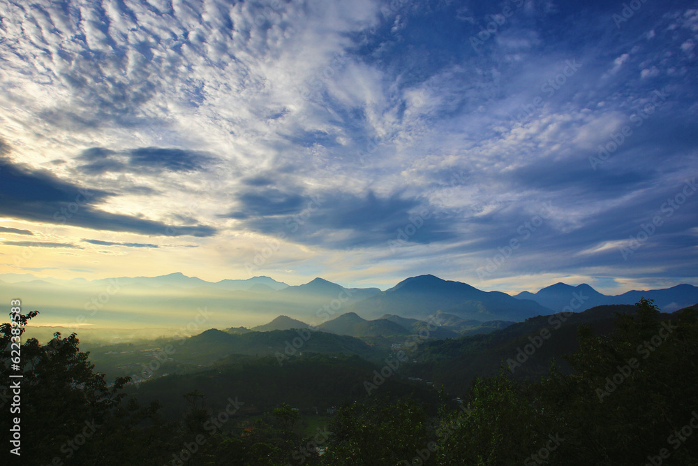 Sunrise landscape with continuous mountains and colorful sky clouds