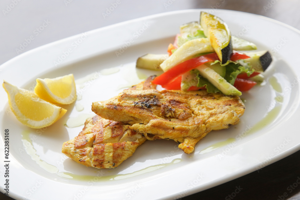 Grilled chicken with grilled vegetables served on the restaurant table Grilled chicken with grilled vegetables served on the restaurant table
