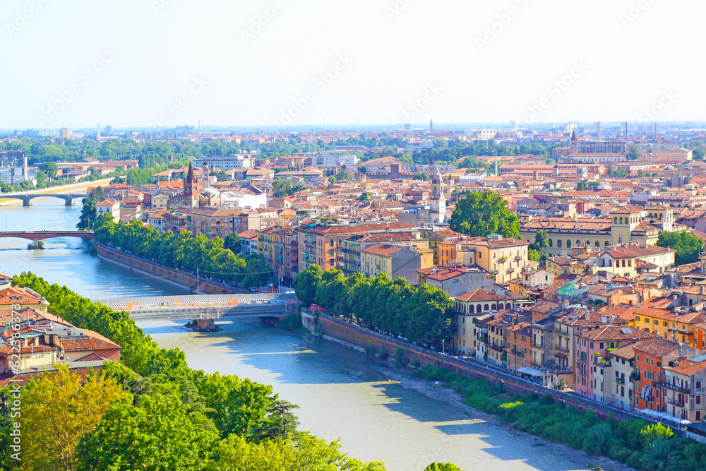 Aerial view of Verona historical city centre, bridges across Adige river, medieval buildings with red tiled roofs, Veneto Region, Italy. Verona cityscape and panoramic view.