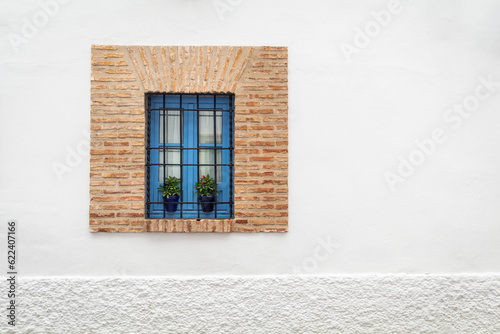 White house with blue window taken in Cordoba, Spain (ID: 622407166)