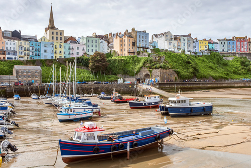 Canvas Print Boats moored in Tenby harbour at low tide in summer, Pembrokeshire Coast Nationa