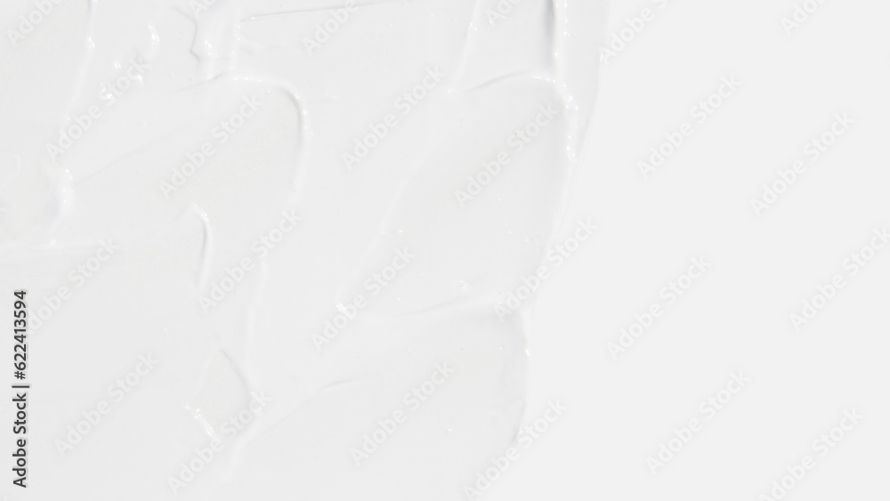 Fototapeta premium White cosmetic cream smeared on a white background