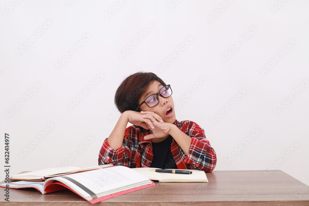 Confused asian student gawking and looking sideways while studying. Isolated on white background Confused asian student gawking and looking sideways while studying. Isolated on white background