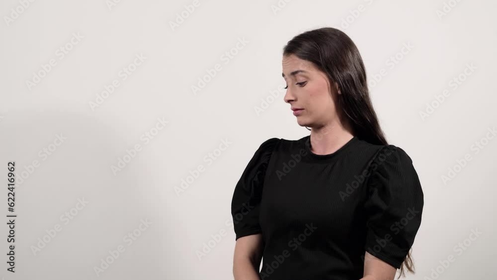 Woman in a black shirt is comparing between two things on a white background Woman in a black shirt is comparing between two things on a white background