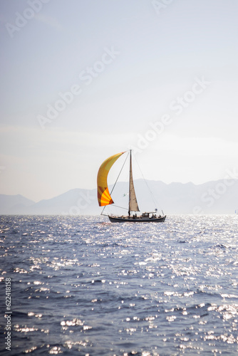 Yellow Sail Boat Progressing On The Open Sea.