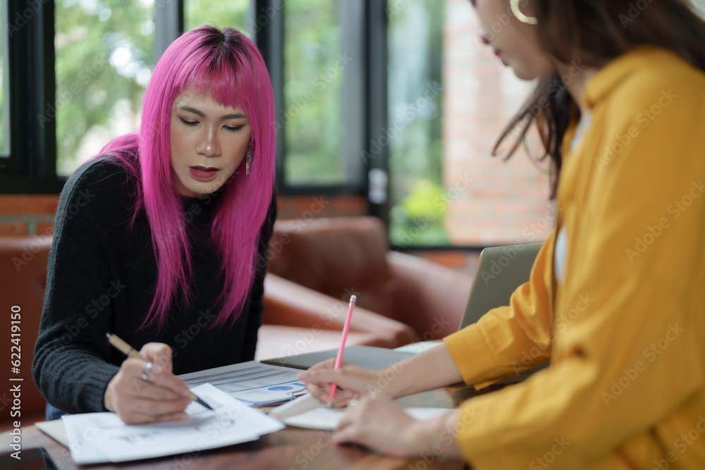Asian transgender Pink Hair Business People Meeting Design Ideas for new start up project working together meeting business plan listen coworker and discussing team work Gender equality LGBTQ+ concept Asian transgender Pink Hair Business People Meeting Design Ideas for new start up project working together meeting business plan listen coworker and discussing team work Gender equality LGBTQ+ concept