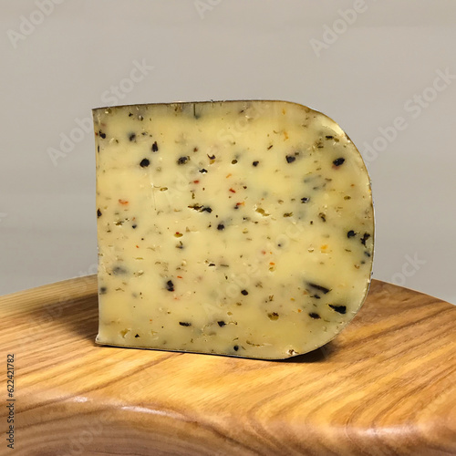 Italian herb-infused premium cheese served on a wooden platter.