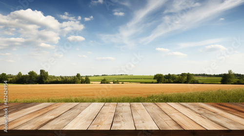 Wooden table with fields and clouds background