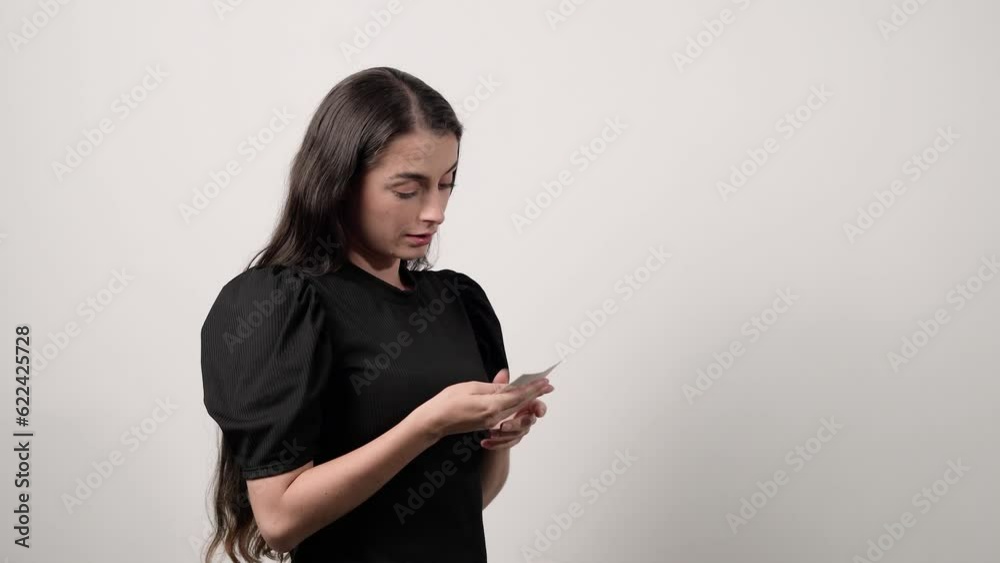 Woman in a black shirt remembering her childhood, embracing a memory, Mom remembering her son looking at a photograph on a white background Woman in a black shirt remembering her childhood, embracing a memory, Mom remembering her son looking at a photograph on a white background