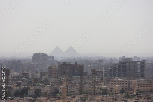 pyramids that are covered in dust in the distance