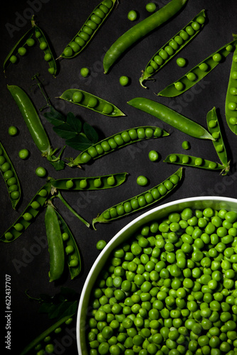 Obraz na płótnie Shelled green peas in a large bowl against a dark background. Top view. w salonie