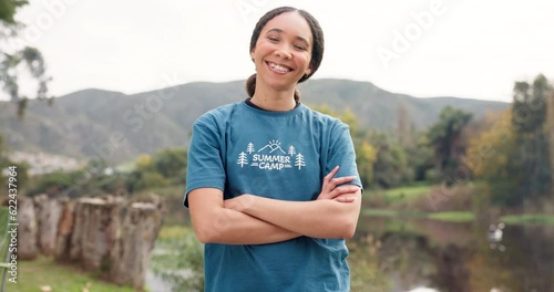Nature, portrait of happy woman with arms crossed at summer camp and counsellor in woods with pride. Forest, lake and face of camping volunteer girl with confidence, support and leadership training.