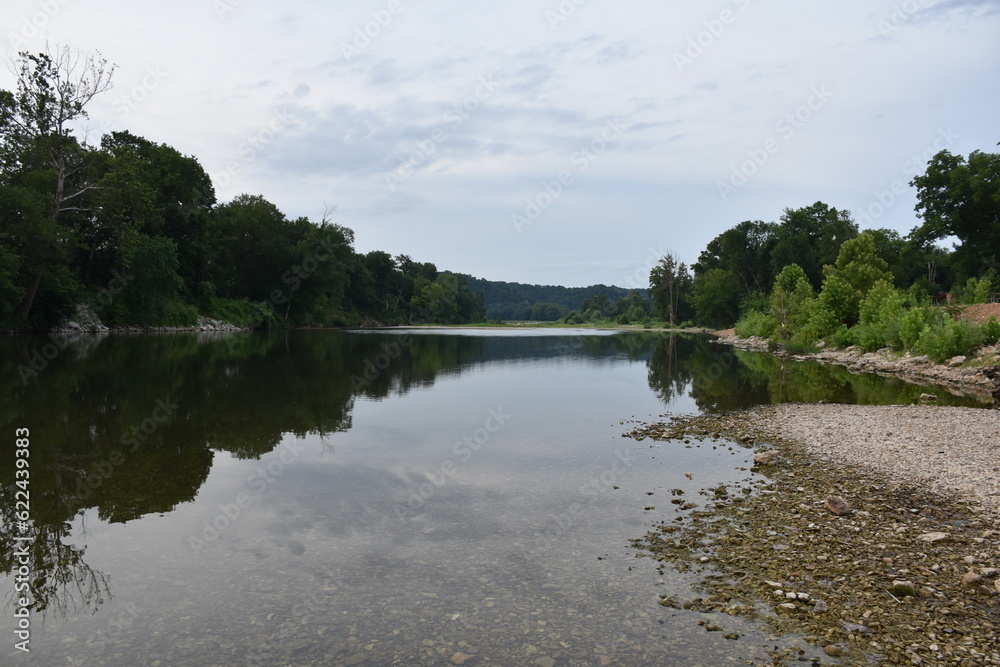 Rocky Shore by a River Under a Cloudy Sky Rocky Shore by a River Under a Cloudy Sky
