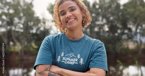 Smile, portrait of woman with arms crossed at summer camp and happy counsellor in nature with pride. Forest, lake and face of camping volunteer girl with confidence, support and leadership training.