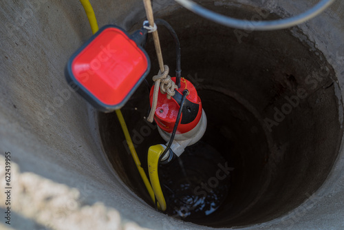 lifting a pump from a deep well to pump water.
