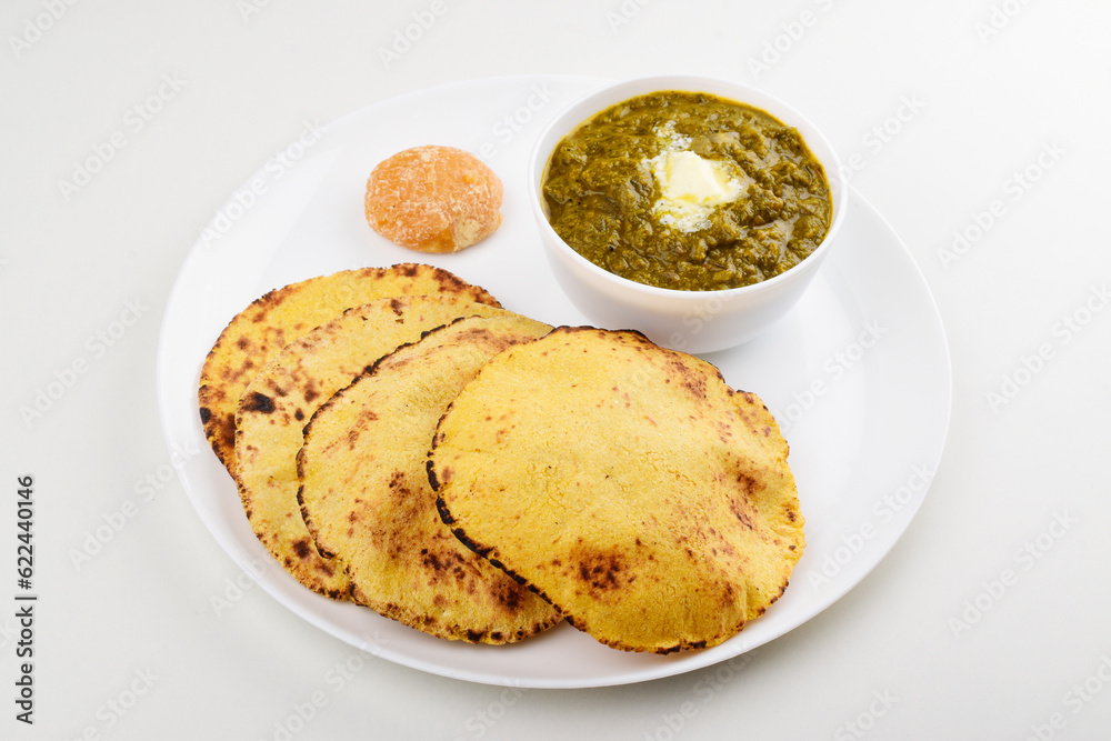 Saag with makki roti in plate on white background Saag with makki roti in plate on white background