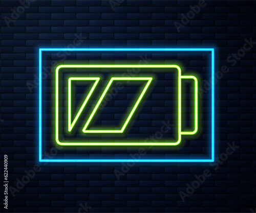 Glowing neon line Battery for camera icon isolated on brick wall background. Lightning bolt symbol. Vector