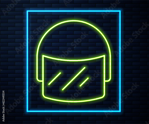 Glowing neon line Police helmet icon isolated on brick wall background. Military helmet. Vector