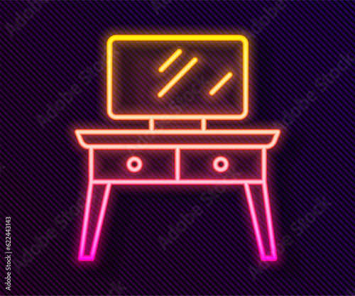 Glowing neon line Dressing table icon isolated on black background. Vector