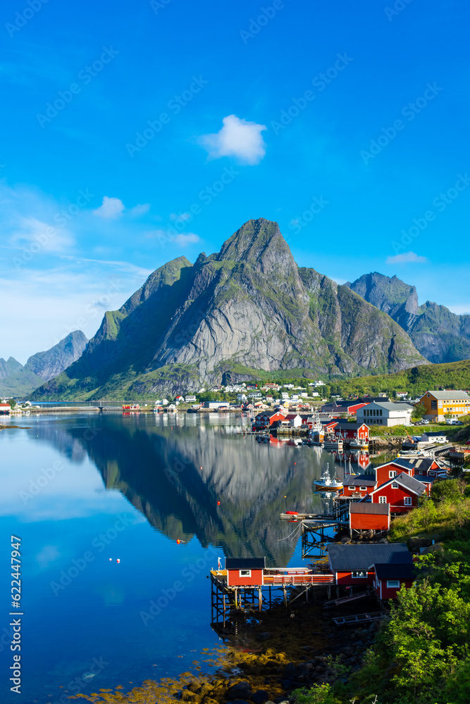 Perfect reflection of the Reine village on the water of the fjord in the Lofoten Islands, Norway