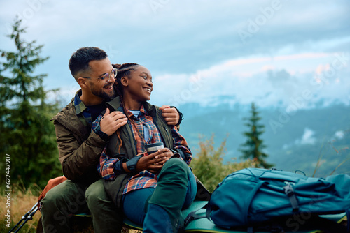 Obraz na plátne Carefree couple enjoys in view while taking break during hiking in nature