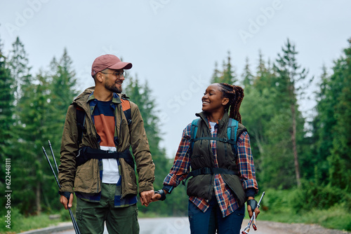 Young happy couple enjoys while hiking in nature.