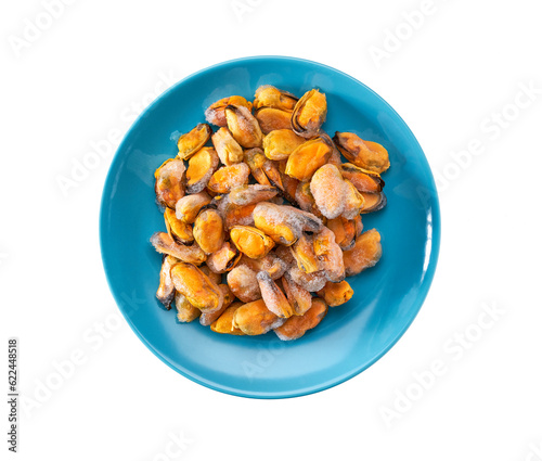 Frozen peeled mussels on a blue ceramic plate isolated on a white background, top view.