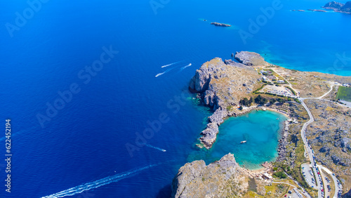 The Acropolis of Lindos in Rhodes island Greece. Saint Paul's Beach and Lindos Acropolis aerial panoramic view.